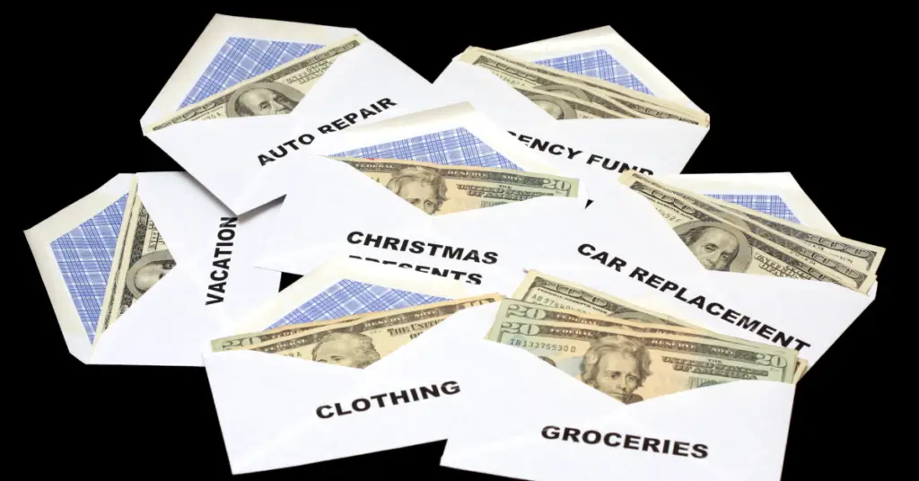 Envelopes that are labeled with bills like "groceries, clothing, etc..." with cash in each.